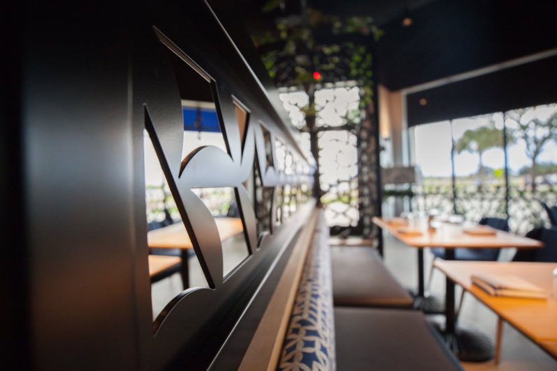 Laser-cut metal screen between the dining rooms