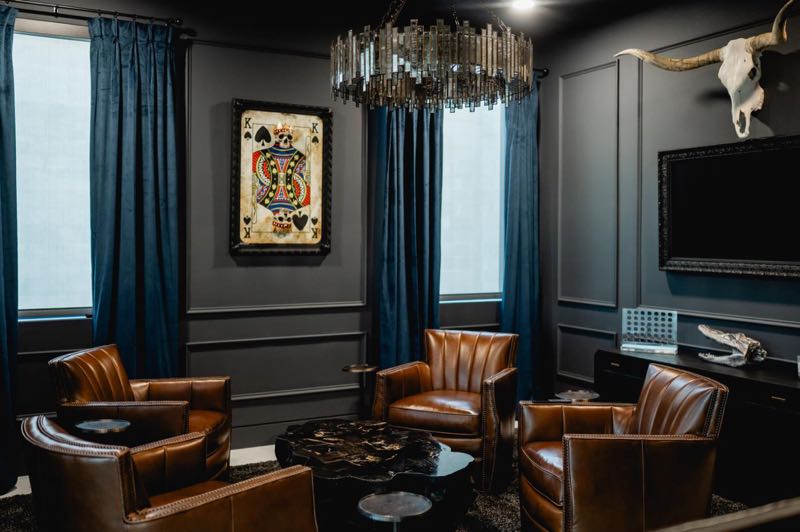 Dark-panelled lounge with leather club chairs