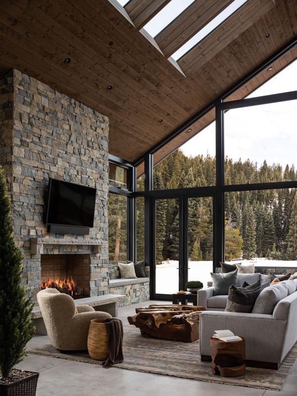 Four-seasons room under the skylights, with the fireplace and the snow outside