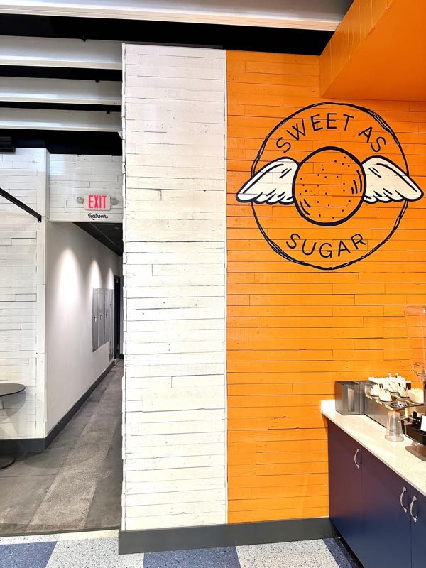 Sugarwings Seminole (2024): menu wall and the orange soffit over the counter